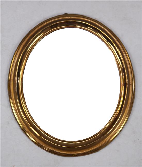 A Biedermeier brass framed oval wall mirror, W.1ft 5in. H.1ft 3in.